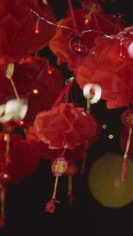 Vertical-Video-Studio-Shot-Of-Chinese-Lanterns-Celebrating-New-Year-With-Falling-Confetti